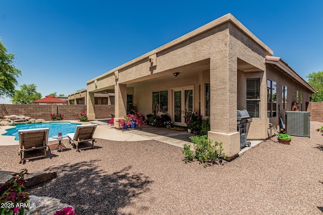 12417 W Apache St, Avondale, AZ 85323 - rear view of house with french doors, a fenced backyard, and a patio area
