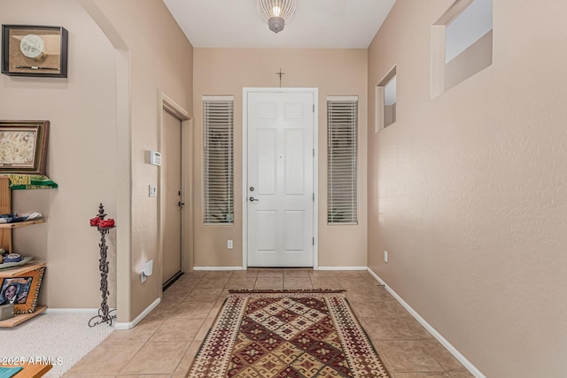 12417 W Apache St, Avondale, AZ 85323 - foyer with arched walkways, light tile patterned floors, and baseboards