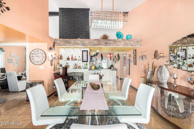 dining space with light tile patterned floors and a high ceiling