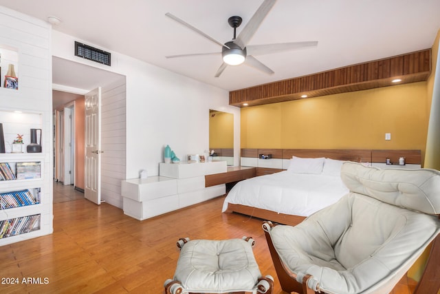 bedroom with light hardwood / wood-style floors and ceiling fan