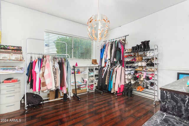 walk in closet with dark hardwood / wood-style flooring