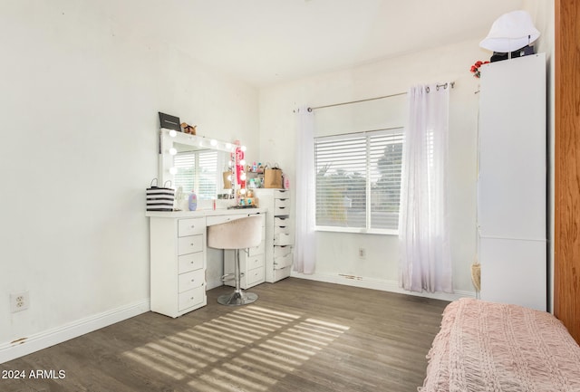 bedroom with dark hardwood / wood-style flooring