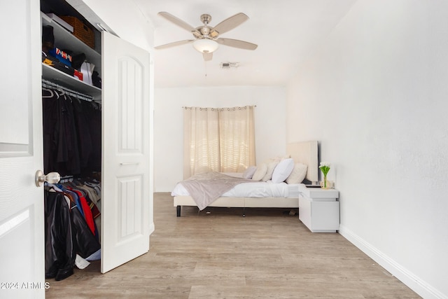 bedroom with ceiling fan, a closet, and light hardwood / wood-style flooring