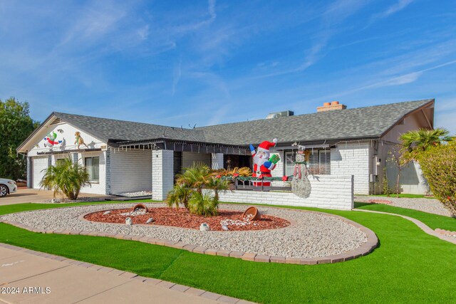 single story home with a front yard and a garage