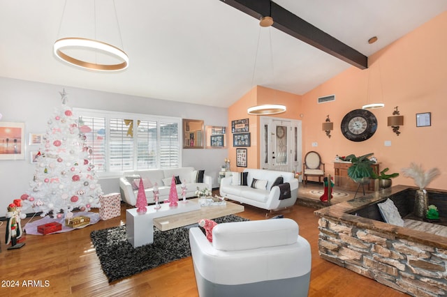 living room with hardwood / wood-style floors and lofted ceiling with beams