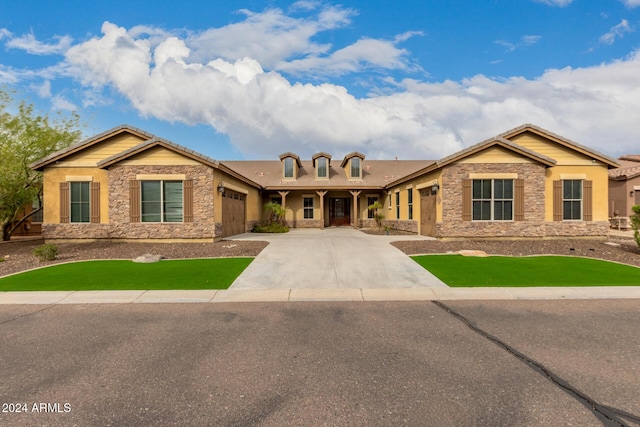 view of front of house with a garage and a front lawn