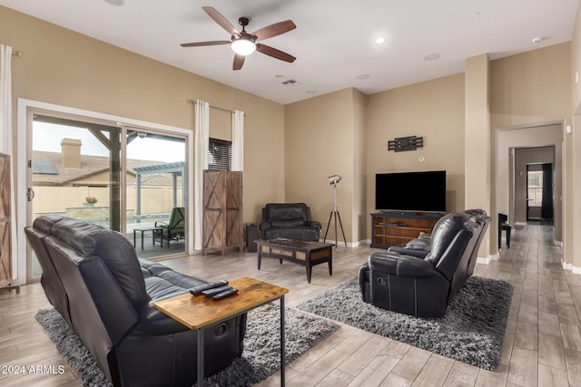 living room featuring ceiling fan and light hardwood / wood-style flooring