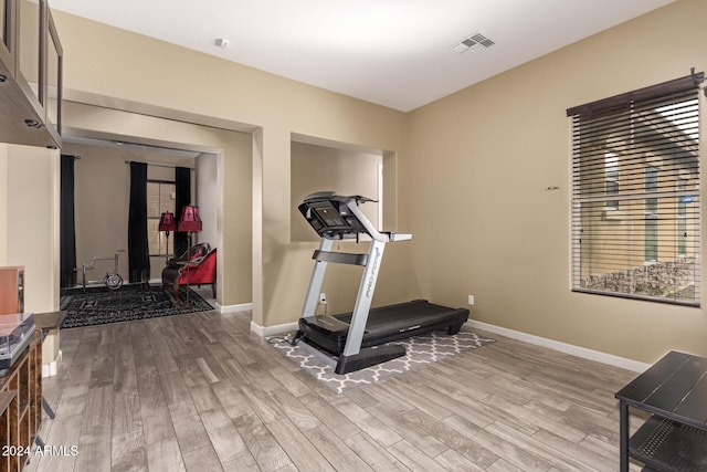 workout area with light wood-type flooring