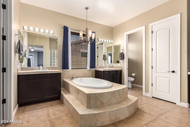 bathroom with tile patterned floors, vanity, tiled tub, and a notable chandelier