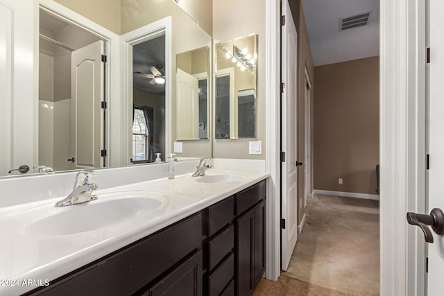 bathroom with tile patterned flooring, vanity, and ceiling fan