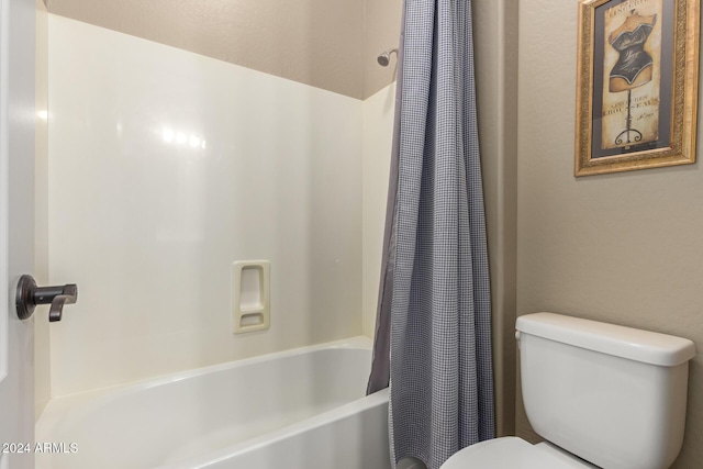 bathroom with shower / bath combo and toilet