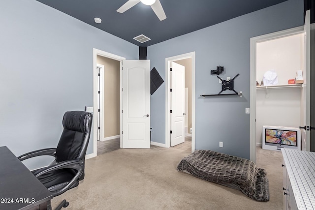 office space with ceiling fan and light colored carpet