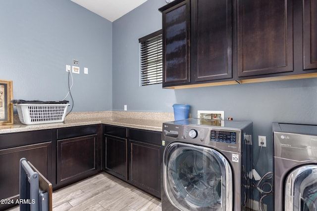 laundry room with cabinets and washing machine and dryer