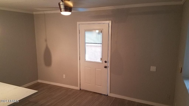 entrance foyer featuring ornamental molding and dark hardwood / wood-style flooring