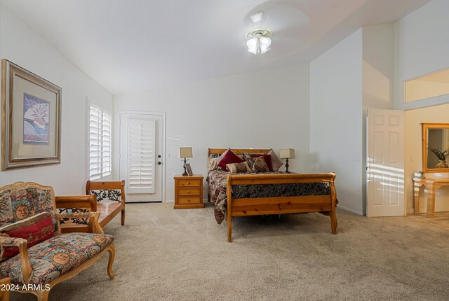 carpeted bedroom with vaulted ceiling