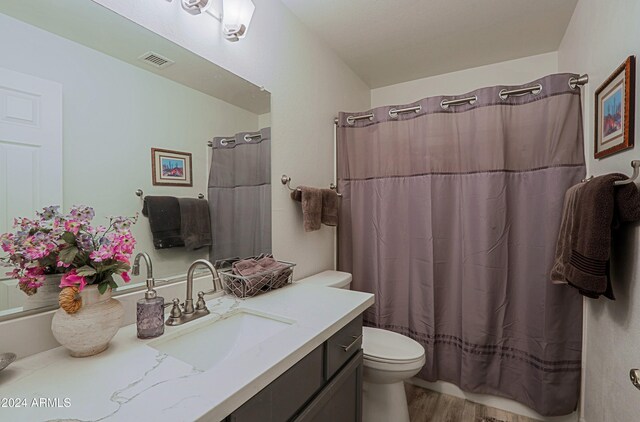 bathroom with vanity, wood-type flooring, and walk in shower