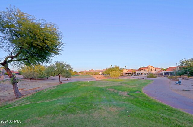 view of home's community featuring a mountain view and a yard