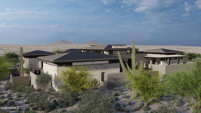 exterior space with a mountain view and stucco siding