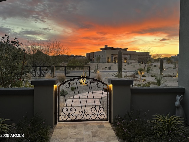 view of gate with a fenced front yard