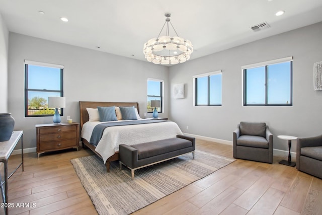 bedroom featuring light wood finished floors, visible vents, recessed lighting, and baseboards