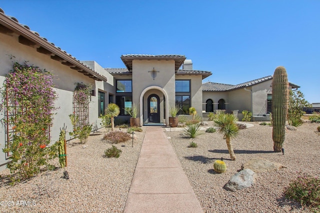 view of front of property with stucco siding and a tiled roof