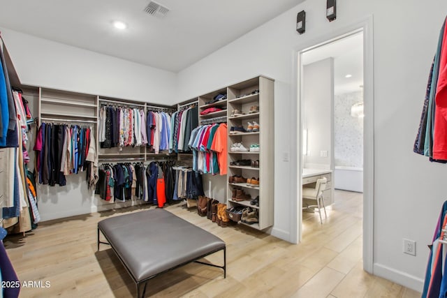 spacious closet featuring visible vents and wood finished floors