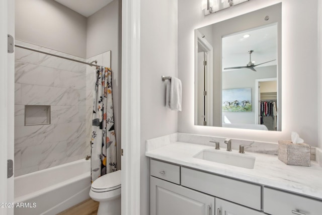 bathroom featuring vanity, shower / tub combo, toilet, and a ceiling fan