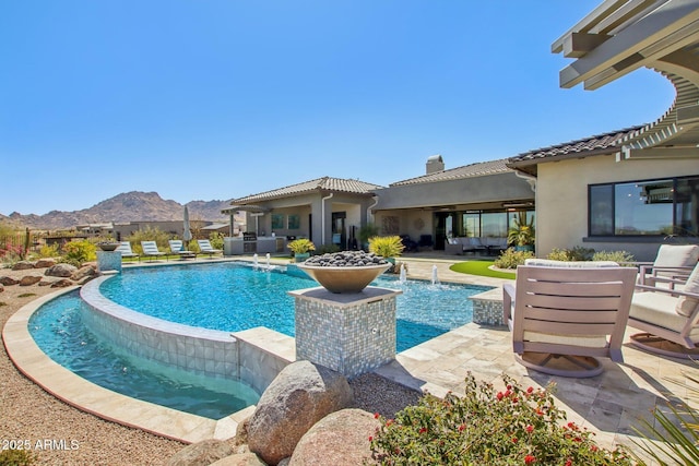 pool featuring a patio and a mountain view