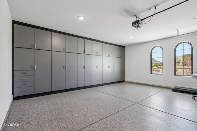 garage featuring recessed lighting, baseboards, and a garage door opener