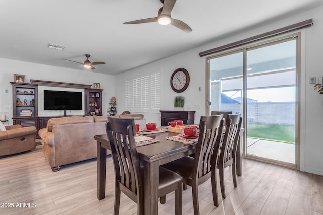 dining room with light hardwood / wood-style flooring and ceiling fan