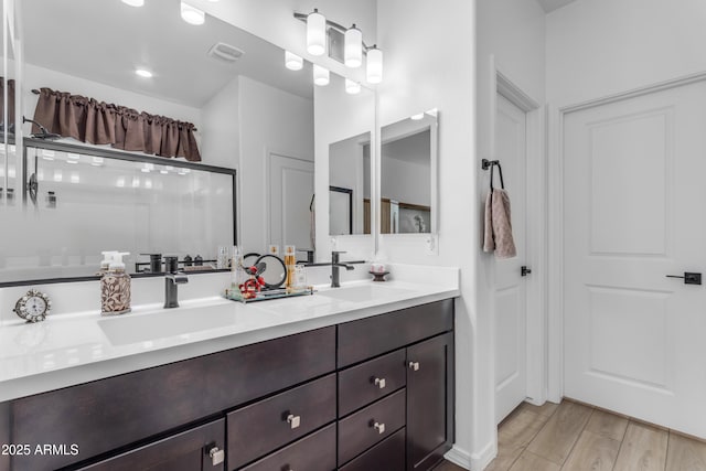 bathroom featuring vanity and an enclosed shower