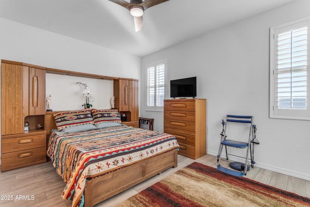 bedroom with ceiling fan and light hardwood / wood-style flooring