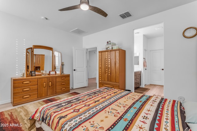 bedroom with light wood-type flooring, connected bathroom, and ceiling fan