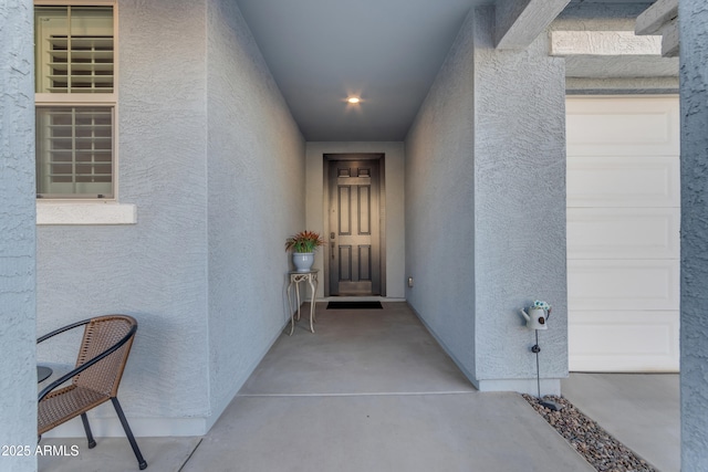 view of exterior entry with a garage