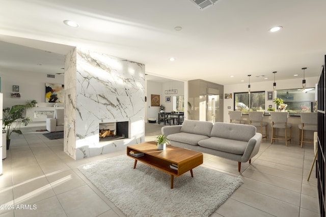 tiled living room featuring a multi sided fireplace