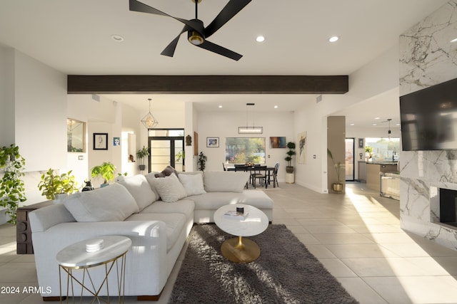 tiled living room featuring beam ceiling and ceiling fan