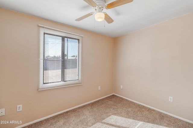 spare room with ceiling fan and carpet