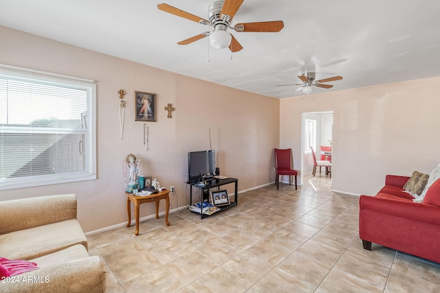 tiled living room featuring ceiling fan