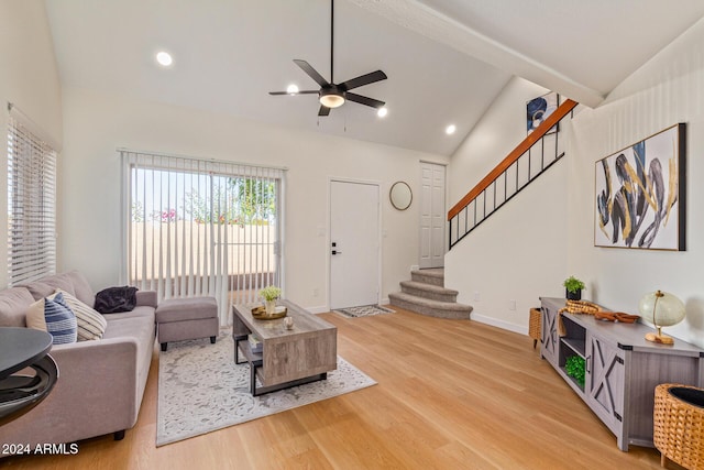 living room featuring lofted ceiling, recessed lighting, light wood-style flooring, baseboards, and stairs