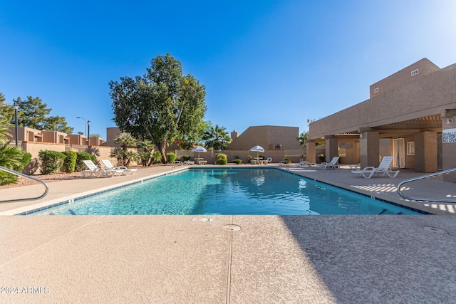 pool featuring a patio and fence