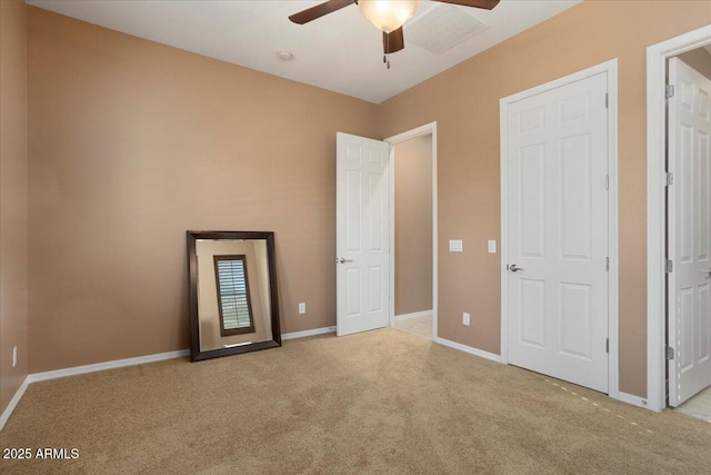 unfurnished bedroom featuring light carpet and ceiling fan