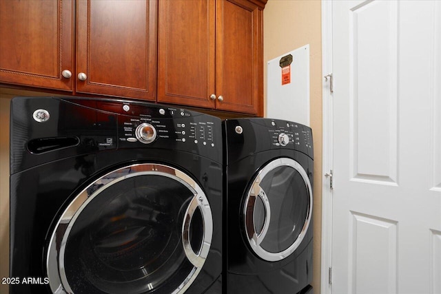 clothes washing area featuring cabinets and washing machine and dryer