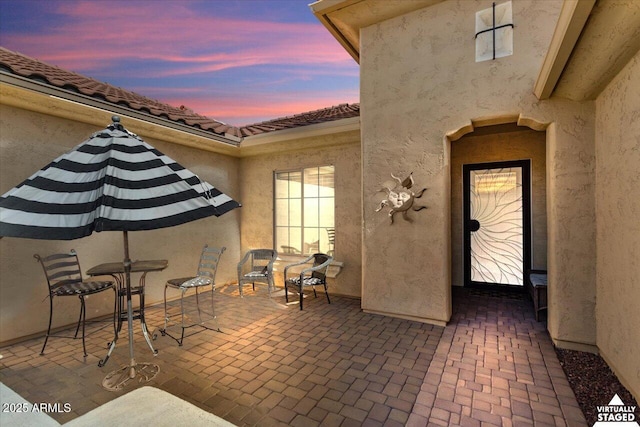 view of patio terrace at dusk