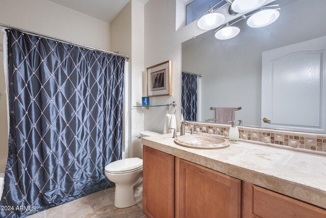 bathroom featuring walk in shower, vanity, toilet, and tile patterned floors