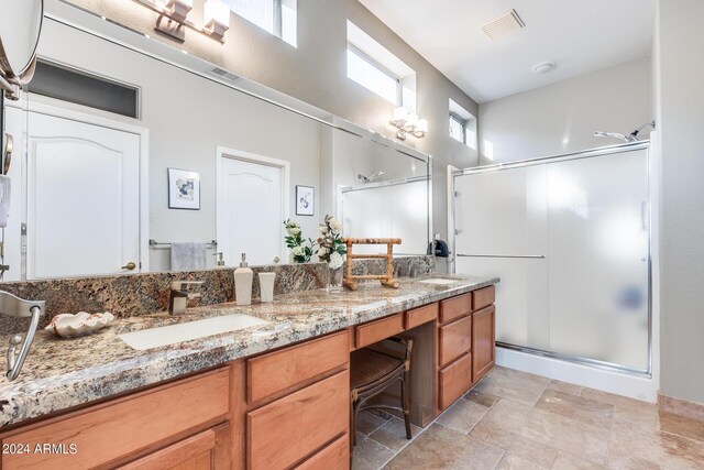 bathroom featuring walk in shower and vanity