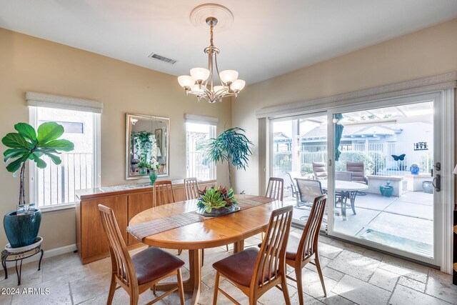 living room featuring ceiling fan with notable chandelier and sink