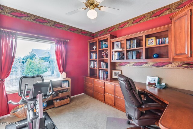 carpeted office featuring ceiling fan