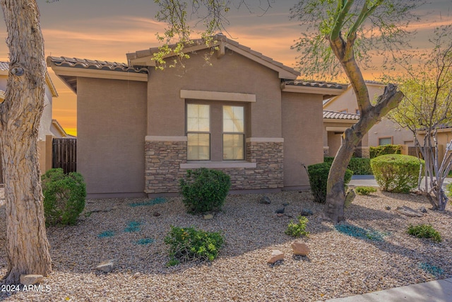 2567 E San Isido Trl, Casa Grande, AZ 85194 - view of front of property featuring a tiled roof, stone siding, and stucco siding