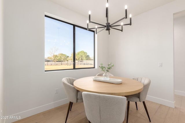 dining space featuring light wood finished floors and baseboards