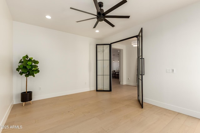 empty room with baseboards, recessed lighting, a ceiling fan, and light wood-style floors